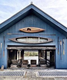 a blue building with a surfboard mounted to it's front door and windows