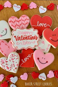 valentine's day cookies are arranged on a table