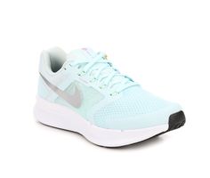 a women's nike running shoe in light blue and white with a black sole