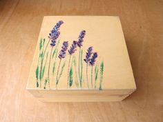 a wooden box with lavender flowers painted on it