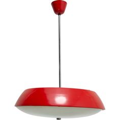 a red and white pendant light hanging from a ceiling fixture with a metal rod in the center