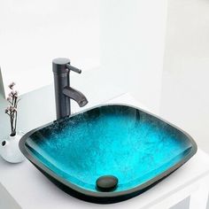 a bathroom sink with a blue glass bowl