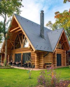 a large log cabin with a black roof