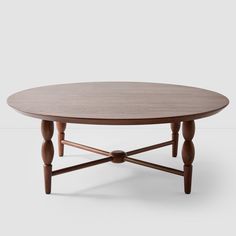 an oval wooden table with two legs and a circular top, on a white background