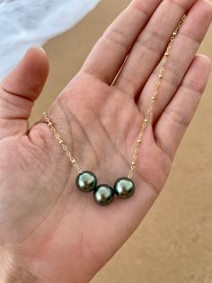 This necklace features three beautiful genuine Tahitian Pearls floating on a satellite chain. PLEASE NOTE: The genuine Tahitian Pearls will vary in shape, size and color and will have natural occurring birthmarks and or pits. They are as nature intended and part of the natural beauty of the pearls. The pearls will range and measure from 8mm to 10mm. These are stock photos, the necklace you receive will be similar but different. All White Sand Jewelry is handcrafted in Hawaii and comes in a hand Cheap Adjustable Pearl Necklace For Beach, Affordable 8mm Bead Pearl Necklace, Luxury Tahitian Pearl Pendant Jewelry, Luxury Tahitian Pearl Jewelry With Pearl Charm, Luxury Tahitian Pearl Round Beads Jewelry, Luxury White Gold Tahitian Pearl Jewelry, Luxury Tahitian Pearl Necklace With Pearl Pendant, Hawaiian Jewelry Necklace, Sand Jewelry