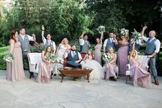 a group of people standing around each other in front of a table with flowers on it