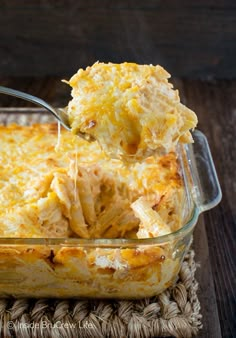 a casserole dish with cheese being lifted from it