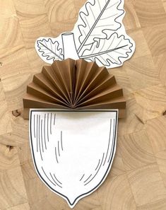 a piece of paper with an image of a leaf and a fan on top of it