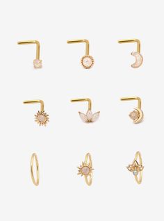 six pairs of gold nose rings with different shapes and sizes, including one for the nose