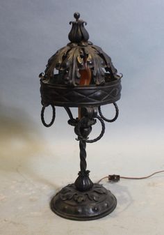 an old fashioned lamp is sitting on a table