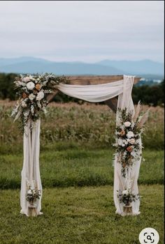 an outdoor ceremony setup with flowers and greenery