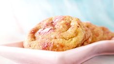 a close up of a muffin in a pink bowl