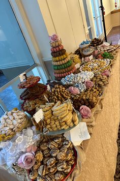 a table filled with lots of different types of cookies and pastries on top of each other