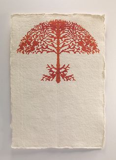 a piece of paper with a red tree on it