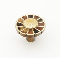 an antique brass knob on a white background