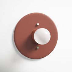 an overhead view of a brown and white light switch on a wall with one button