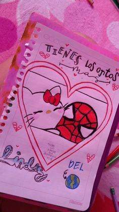 a pink notebook with a drawing of a spiderman in the shape of a heart