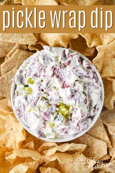 a white bowl filled with pickle wrap dip surrounded by tortilla chips