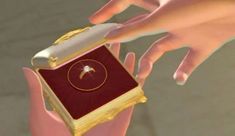 a person holding an open box with a diamond in it's center and another hand reaching out towards it