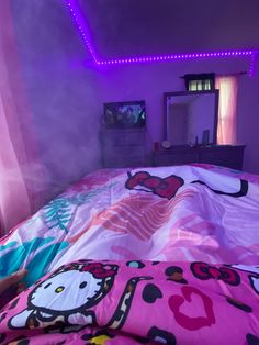 a bedroom with a hello kitty comforter on the bed and pink sheets in the room