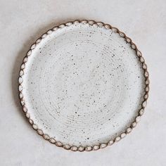 a white and brown plate sitting on top of a table