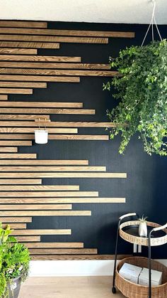 a wooden wall with plants in it and a basket on the floor next to it