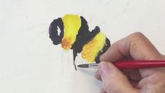 someone is drawing a bee on paper with colored pencils