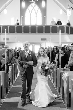 the bride and groom are walking down the aisle