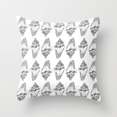 a white pillow with black and white drawings on it