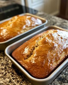 two loafs of banana bread sitting on top of a counter next to each other