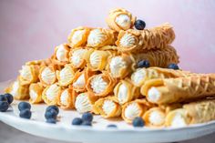 blueberries and cream crepes stacked on top of each other