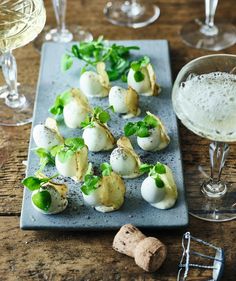 an assortment of appetizers and wine glasses on a table