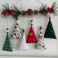 an assortment of christmas trees hanging on a wall