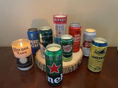 there are many different types of beer on the table with candles in front of them