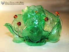 two green glass vases sitting on top of a table