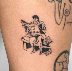 a person with a tattoo on their leg holding a sign that says end is near