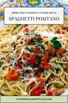 spaghetti with tomatoes, parmesan cheese and basil on a blue and white plate