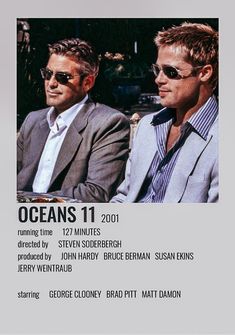 two men sitting next to each other in front of a white sign that says ocean's 11