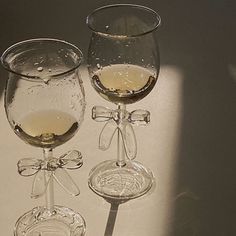 two wine glasses sitting next to each other