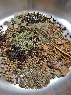 an assortment of spices and herbs in a bowl