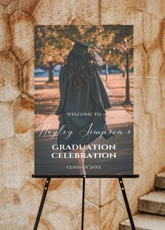 a sign that is standing up in front of a stone wall with the words happy america's graduation celebration written on it