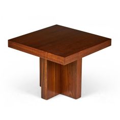 a square wooden table sitting on top of a white floor