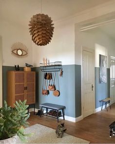 a living room with blue walls and wooden furniture