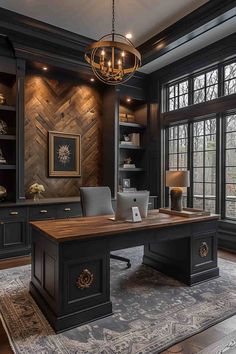 an elegant home office with wood paneled walls and black desks, chandelier, and built - in bookshelves