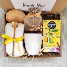 a gift box filled with tea, cookies and other items for someone's special occasion