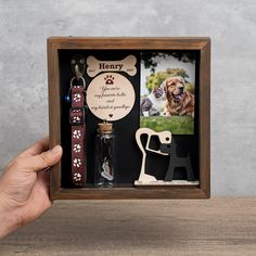 a dog's paw print is displayed in a wooden box with personalized items