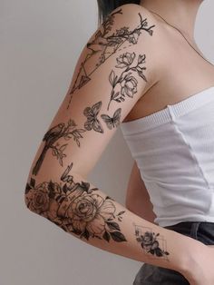 a woman with tattoos on her arm and shoulder