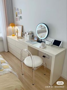 a white desk with a mirror and chair in front of it on top of a hard wood floor