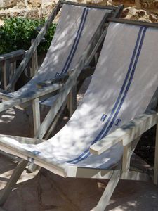 two lawn chairs sitting next to each other