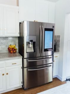 a stainless steel refrigerator in a white kitchen